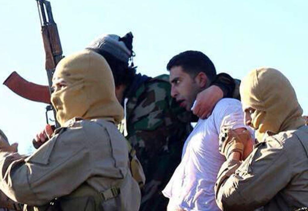 Боевики Исламского государства ведут захваченного Моаза Аль-Кассабеха.